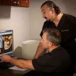 Dr. Sawisch and Dr. Schetritt looking at a computer screen
